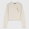 Pull avec broche florale Pull avec broche florale